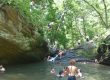 A man dives into “Devil’s Pool” at the confluence of the Cresheim and Wissahickon Creeks in June 2025.