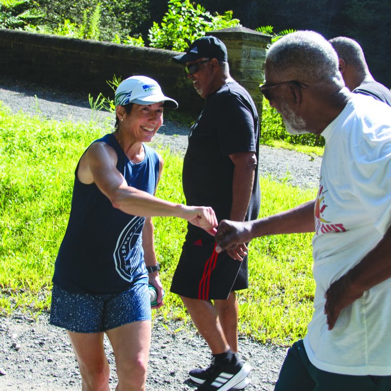Joe Jamison greets Kathryn Rapp during a walk with Bruce Ross (in black) and Al Walker. Photo by Brian Nelson