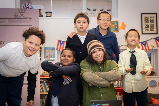 Jeán Ruiz poses with students in Taller Puertorriqueño's CEP (Cultural Enrichment Program). (Justin Plant for Chalkbeat)