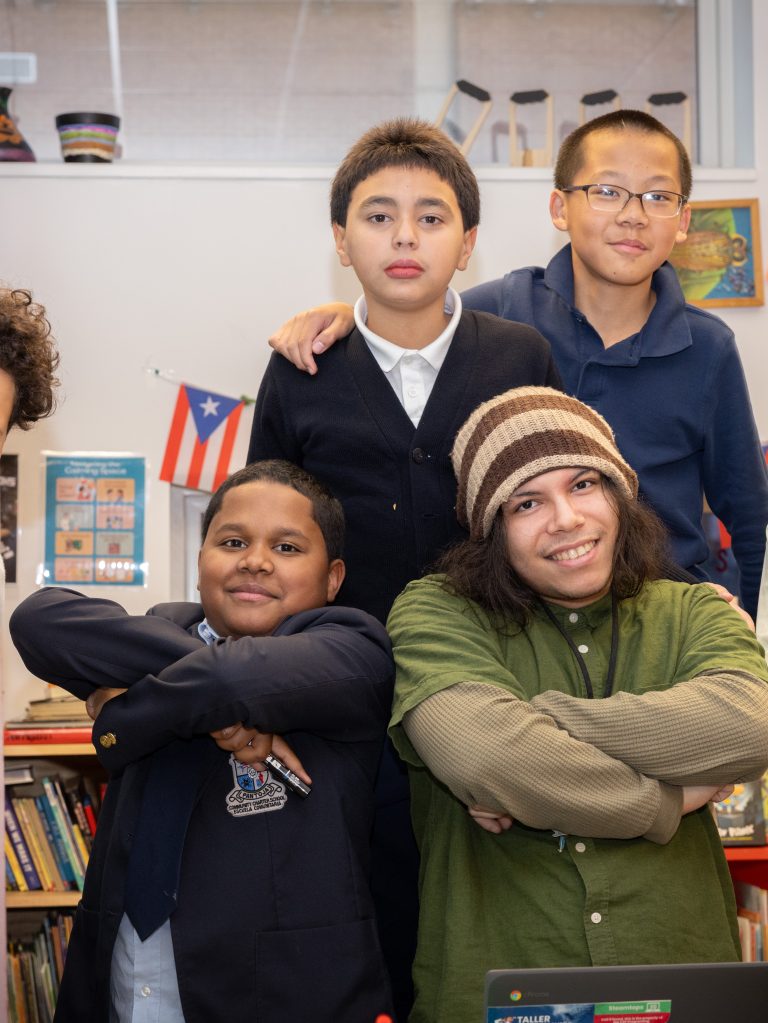 Jeán Ruiz poses with students in Taller Puertorriqueño's CEP (Cultural Enrichment Program). (Justin Plant for Chalkbeat)