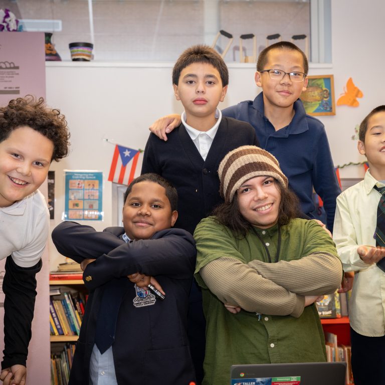 Jeán Ruiz poses with students in Taller Puertorriqueño's CEP (Cultural Enrichment Program). (Justin Plant for Chalkbeat)