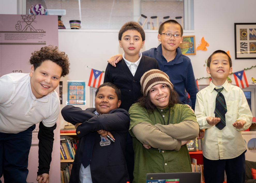 Jeán Ruiz poses with students in Taller Puertorriqueño's CEP (Cultural Enrichment Program). (Justin Plant for Chalkbeat)