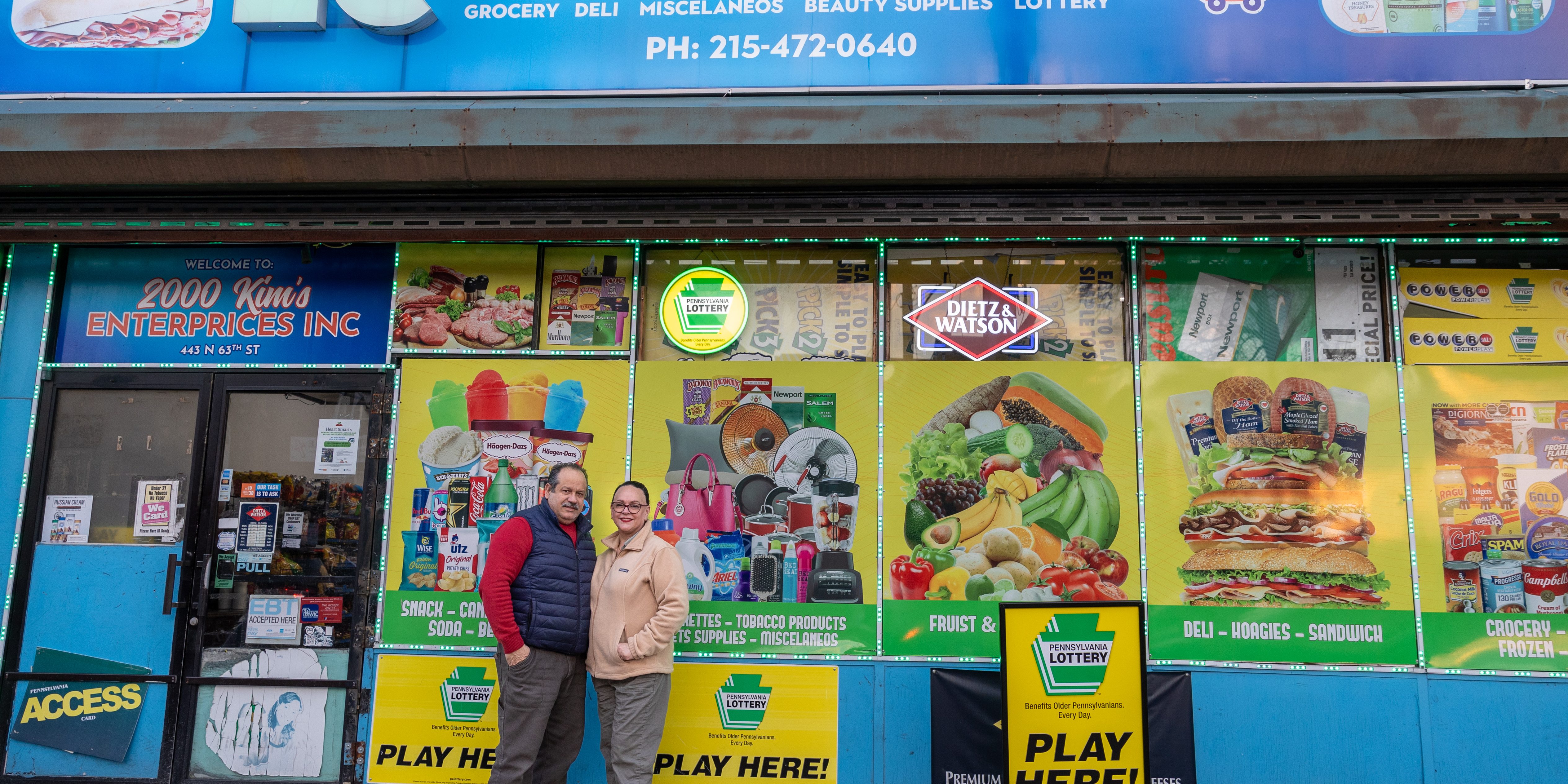 Clara Olivares and her husband are pictured outside their bodega, EC Food Market, in West Philadelphia.