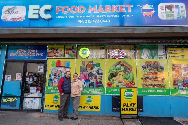 Clara Olivares and her husband are pictured outside their bodega, EC Food Market, in West Philadelphia.