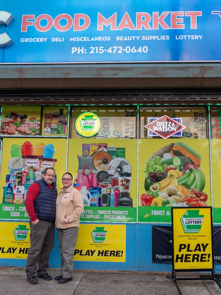 Clara Olivares and her husband are pictured outside their bodega, EC Food Market, in West Philadelphia.