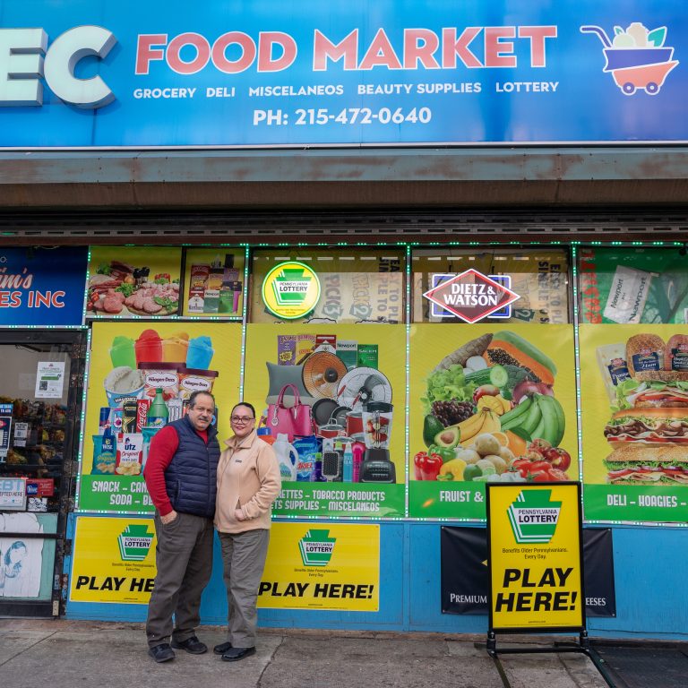 Clara Olivares and her husband are pictured outside their bodega, EC Food Market, in West Philadelphia.
