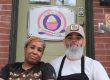 Photo of Terrance and Rashida Baldwin on the steps in front of Lily of the Valley bakery that they have run for 13 years.