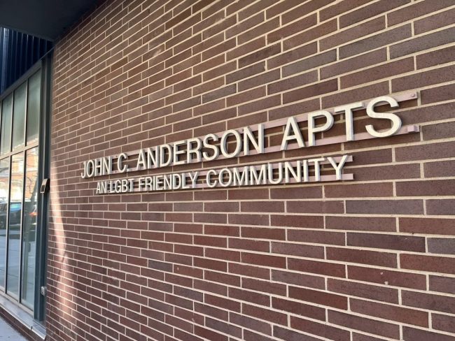 A photo of the sign on the building of the John C. Anderson Apartments in Philadelphia's Gayborhood.