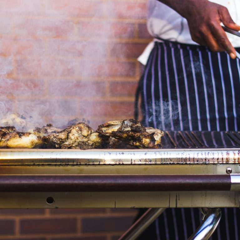 connor-pope-6f38y7nmp3s-unsplash Stock image of a person grilling chicken.
