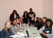 Germantown residents and staff of Germantown Info Hub gather around a table at an April discussion of the "benefits cliff" at the Our House Cultural Center.
