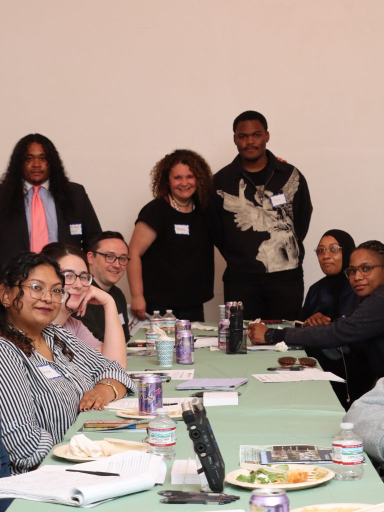Group Shot Germantown residents and staff of Germantown Info Hub gather around a table at an April discussion of the "benefits cliff" at the Our House Cultural Center.