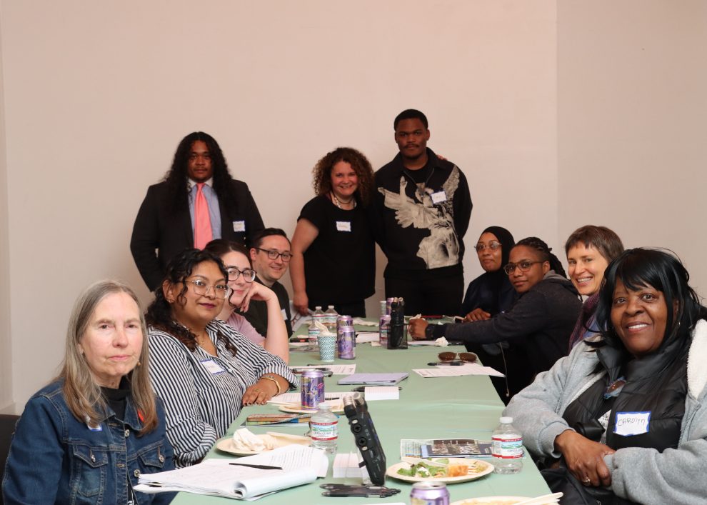 Germantown residents and staff of Germantown Info Hub gather around a table at an April discussion of the "benefits cliff" at the Our House Cultural Center.