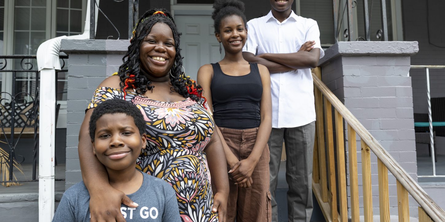 Michelle “MiMi” Gravley, 38, and her children — from left to right: Boots, 11, Buttons, 17, and Chippy, 14 — stand on the porch of their North Philadelphia home.