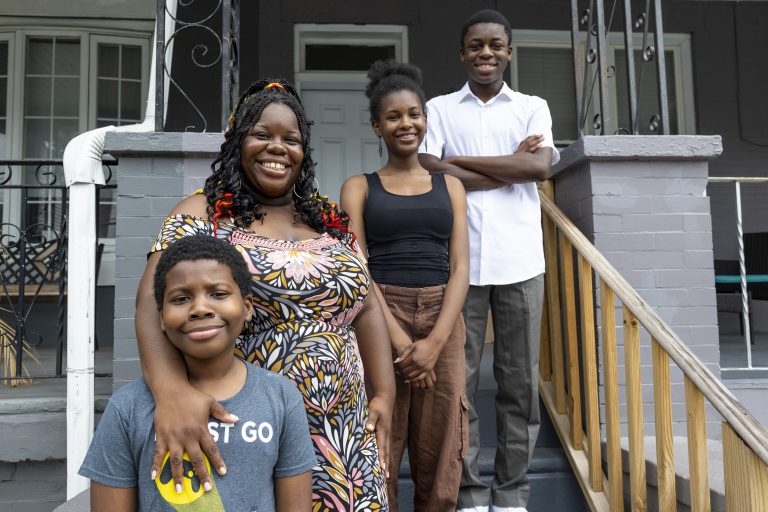 Michelle “MiMi” Gravley, 38, and her children — from left to right: Boots, 11, Buttons, 17, and Chippy, 14 — stand on the porch of their North Philadelphia home.