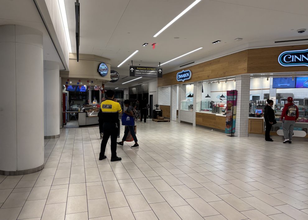 A security guard watches the entrance to Fashion District mall from the Market Frankfort Line.